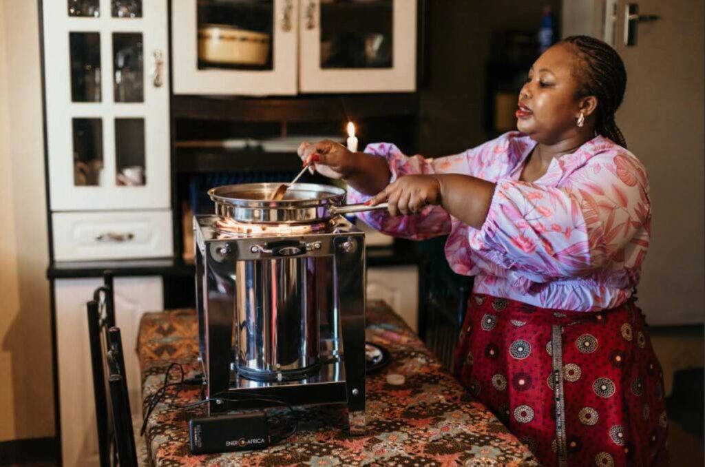 A woman cooking on a pellet-fueled stove– Ener-G-Africa Zambia