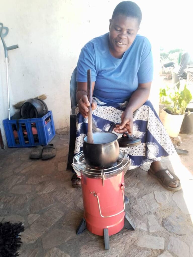 Woman in Zimbabwe preparing food on a sustainable cookstove - Powerlive