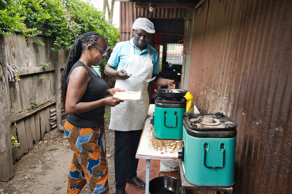 Cooking food on EcoSafi stove - Jason Mulikita